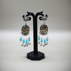 Mantra Engraved Oxidized Jhumka Earrings With White-Blue Beads