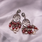 Mantra Engraved Oxidized Jhumka Earrings With Red Beads